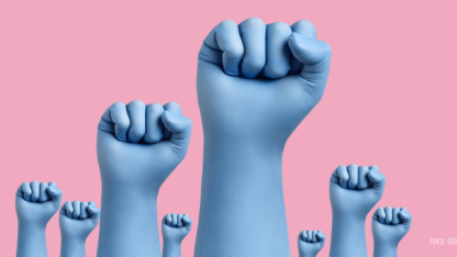 Nahaufnahme mehrerer erhobener Fäuste mit blauen Latexschutzhandschuhen auf rosa Hintergrund